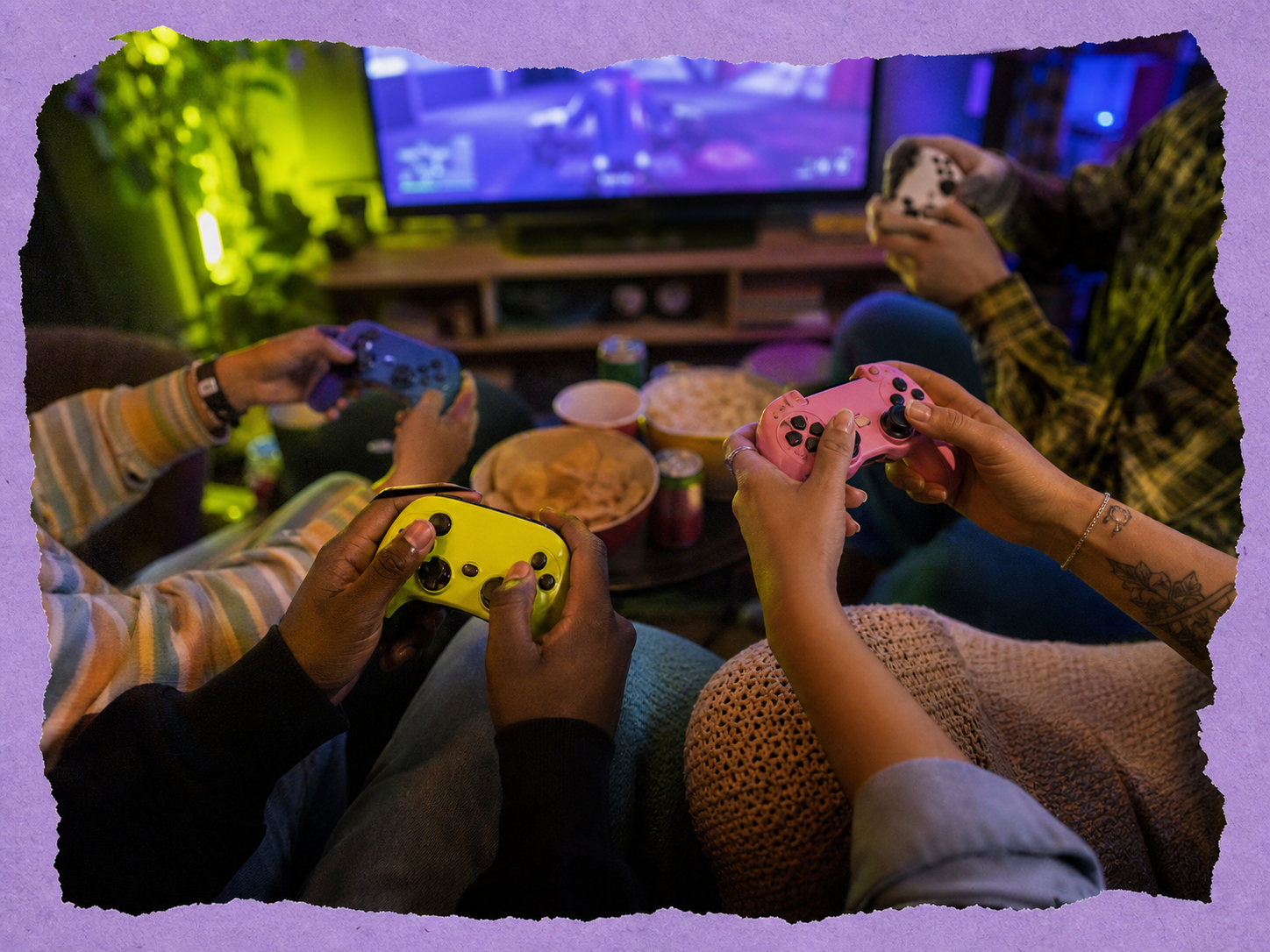 Original colourful photo of people sharing game controllers in a lounge