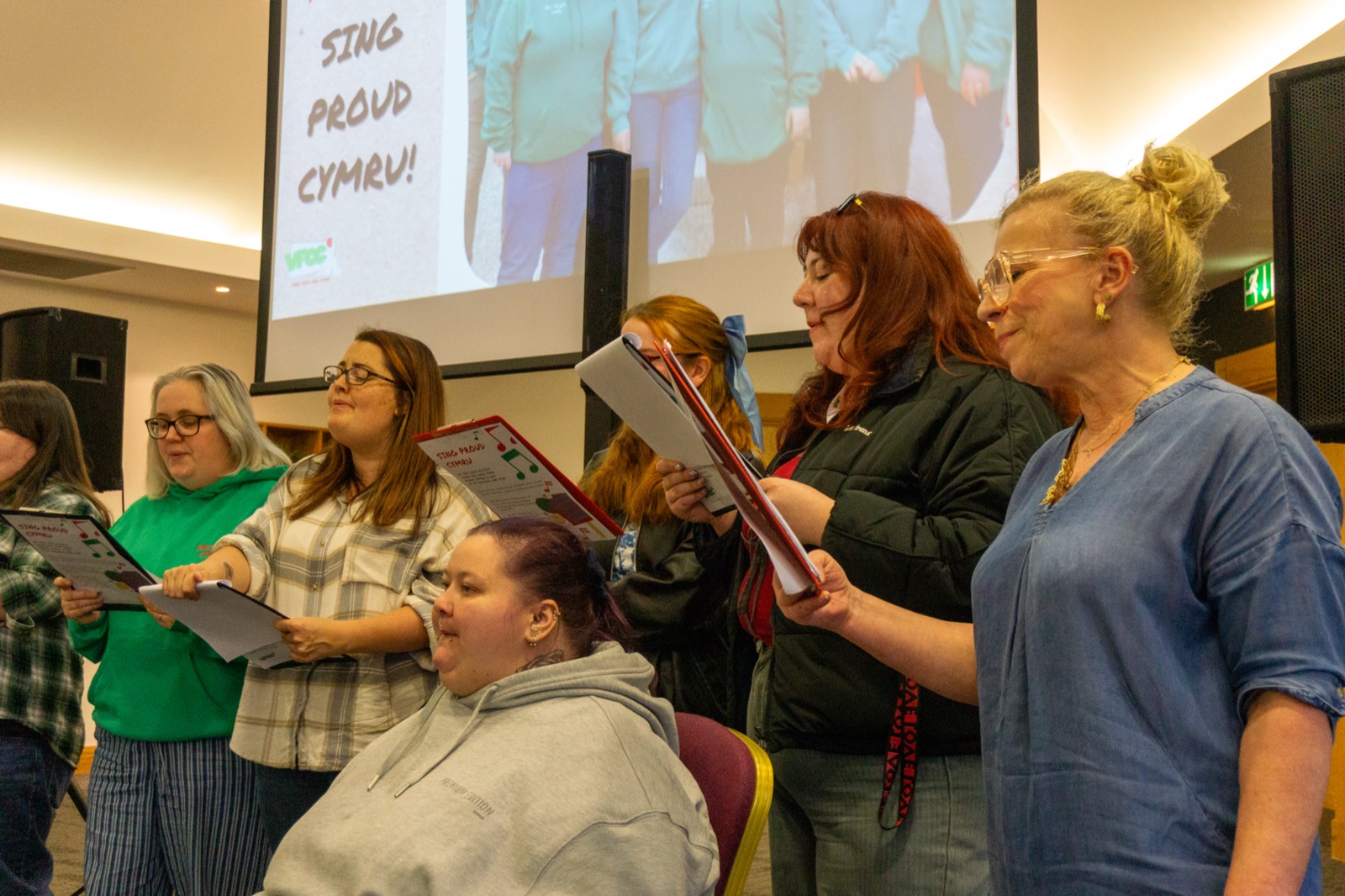 Group singing Sing Proud Cymru at a VFCC event